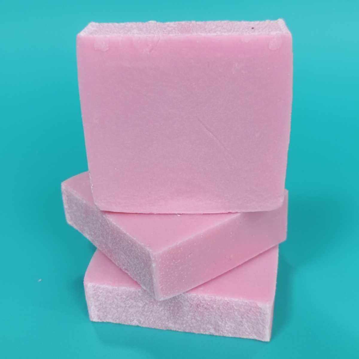 A stack of three pink rectangular bars against a teal background.