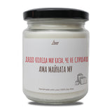 a jar of white candle with a black lid