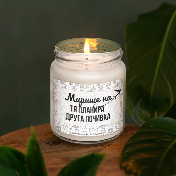 a white candle sitting on top of a wooden table