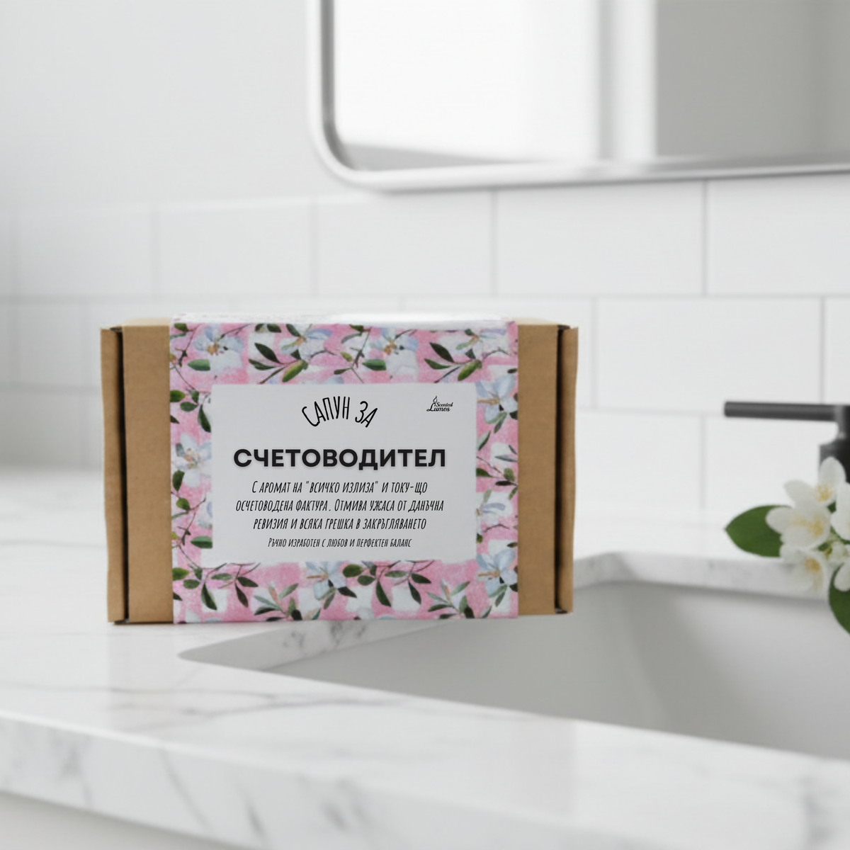 A cardboard box with a floral pattern and text in Russian, placed on a white countertop next to a sink.