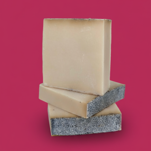 three rectangular blocks of cheese stacked on top of each other against a red background.