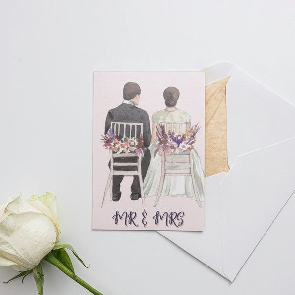 a card with a picture of a couple sitting on a bench