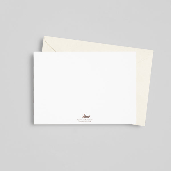 a white envelope with a white card on top of it