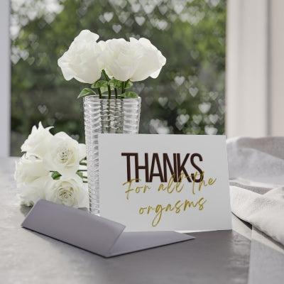 a vase with white flowers and a card that says thanks for all the organics