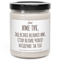 a jar of white candle with a black lid
