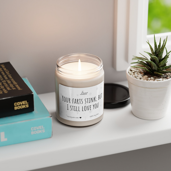 a candle sitting on top of a table next to a book