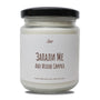 a jar of white candle sitting on top of a table