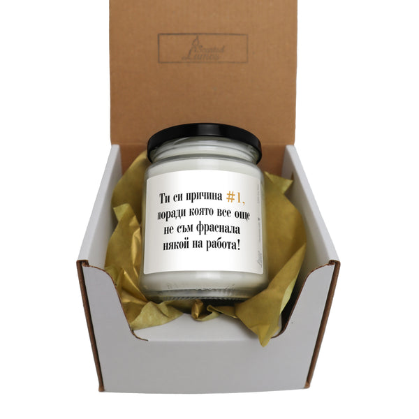 a candle in a gift box with a note on it