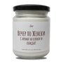 a jar of white candles with a black lid
